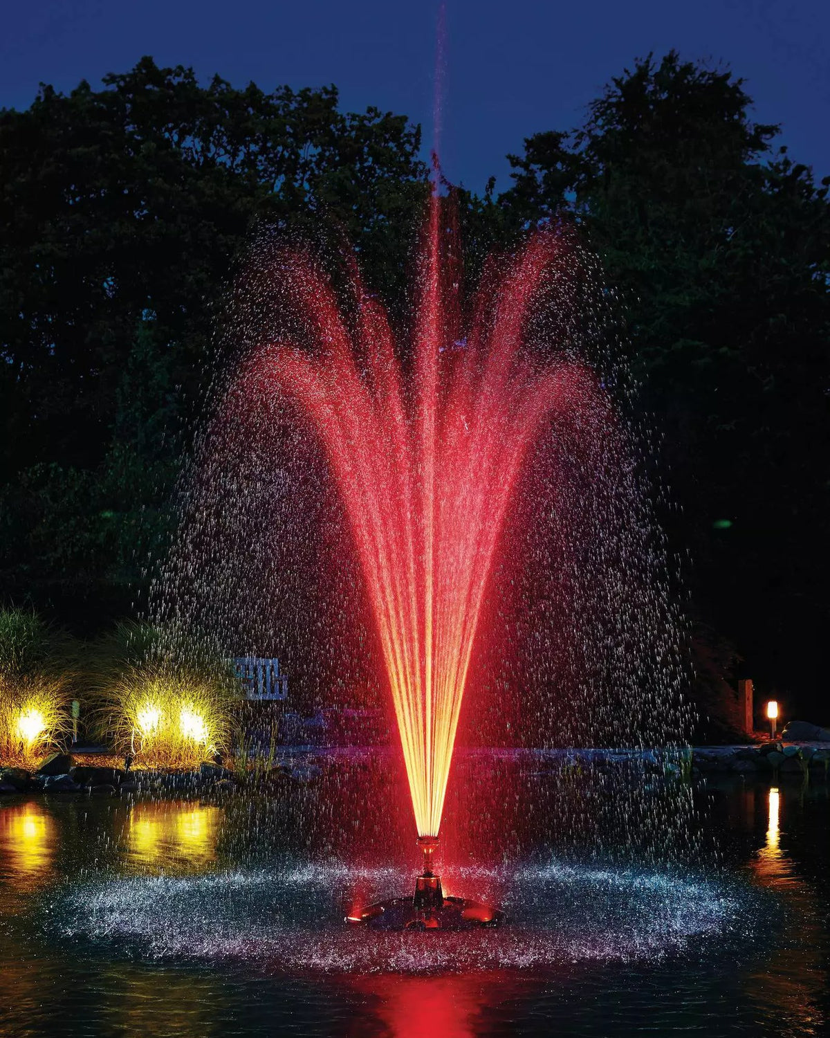 Schwimmfontäne nachts rot beleuchtet mit dem OASE Beleuchtungsset RGB